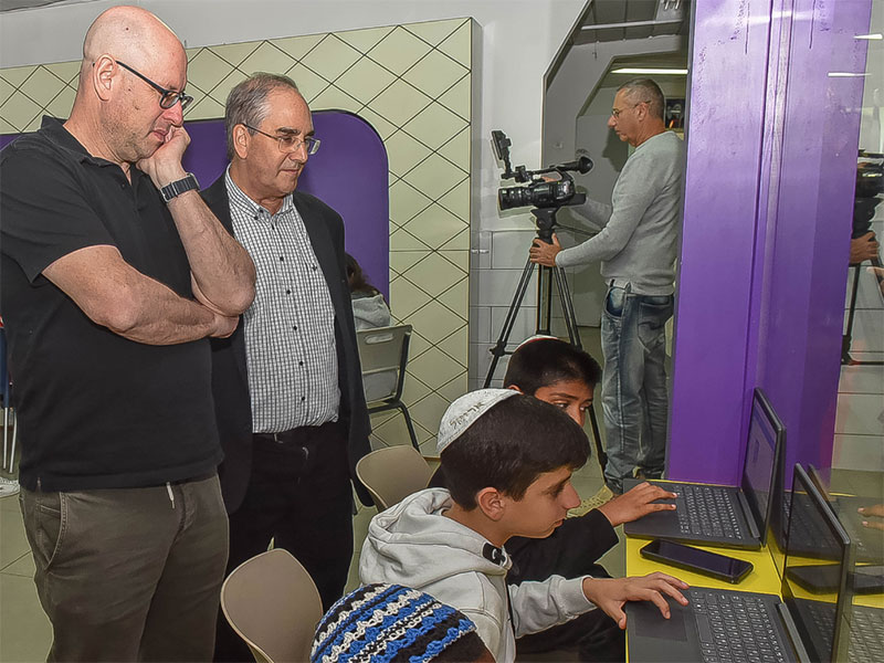 Gideon Stein, President of the Moriah Fund, and Don Futterman, ICEI Executive Director, look on as fifth-grade students demonstrate the impressive features of LightSail.