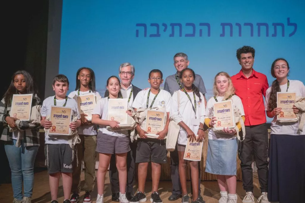 A group photo of the students with the certificates of appreciation